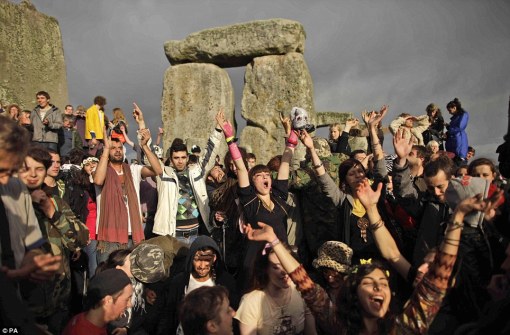 solstice-2011-stonehenge Here comes the sun: Revellers cheer as the sun finally breaks through the clouds, more than a couple of hours after daybreak