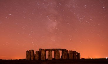 The Perseid meteor shower streaks past Stonehenge in Salisbury Plain. Photograph: Kieran Doherty / Reuters